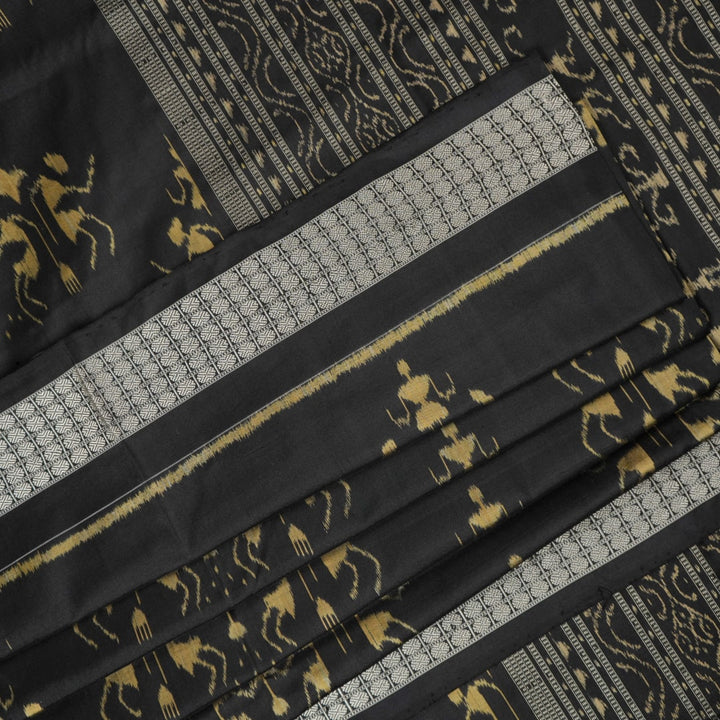 Close-up of the lustrous black Sambalpuri silk fabric, revealing its luxurious texture and fine weave.
