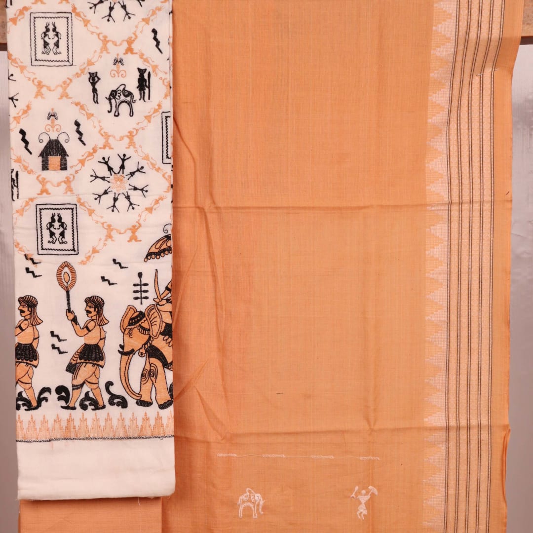 Detail of brown and white cotton Sambalpuri dress material with a doll pattern on a white background