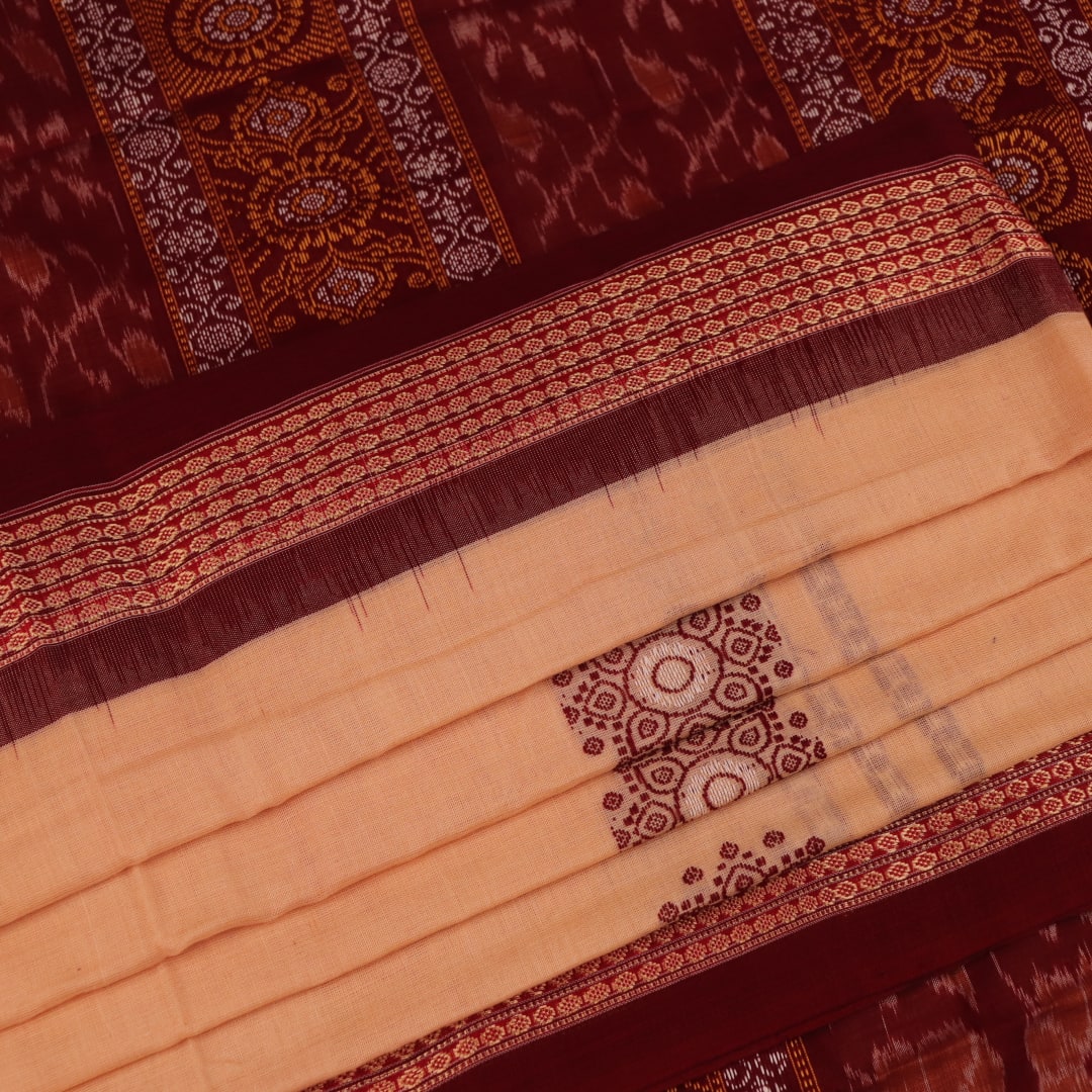 Full view of a cream cotton Bomkai saree with a maroon butta pattern.