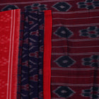 Gracefully draped blue Sambalpuri cotton saree with red motifs, highlighting its design and flow.