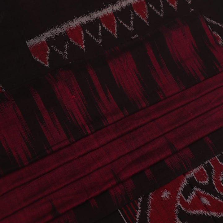 Plain maroon and black Sambalpuri cotton saree, elegantly draped.