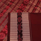 An approximately 150 cm wide handloom black silk Sambalpuri Saree with maroon motifs, captured in a close-up to depict its rich fabric texture.