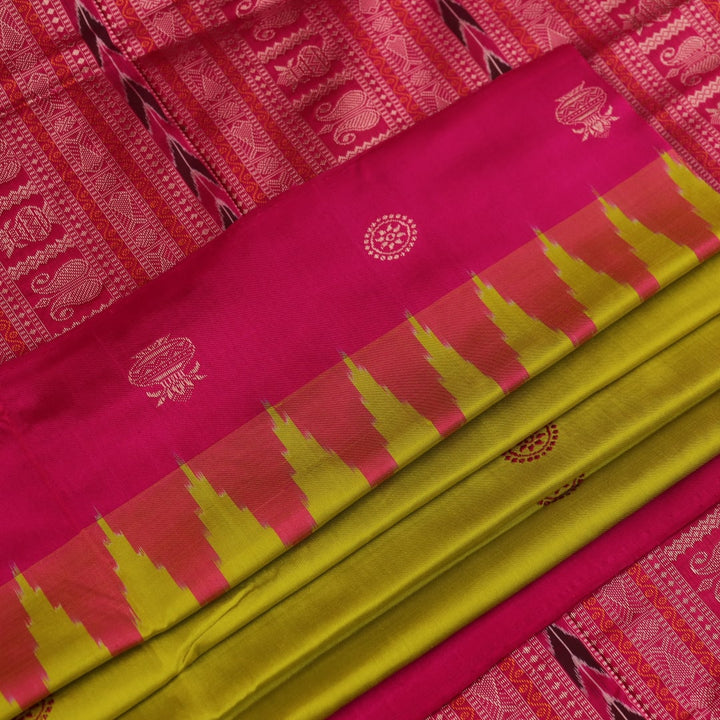 Close-up of green and magenta Bomkai silk saree fabric texture, highlighting intricate weave and butta pattern.