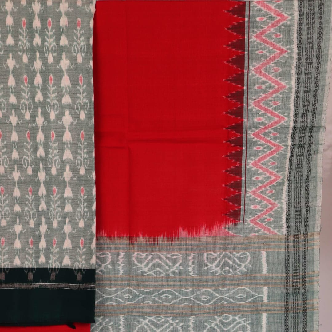 Close-up of a blouse piece in green and red cotton Sambalpuri fabric with motif patterns.