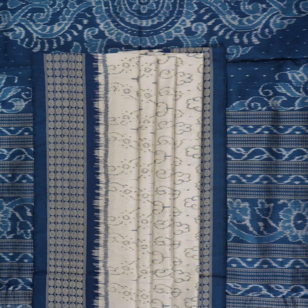 Close-up of premium fabric texture and handloom weave on a white and blue Sambalpuri silk saree