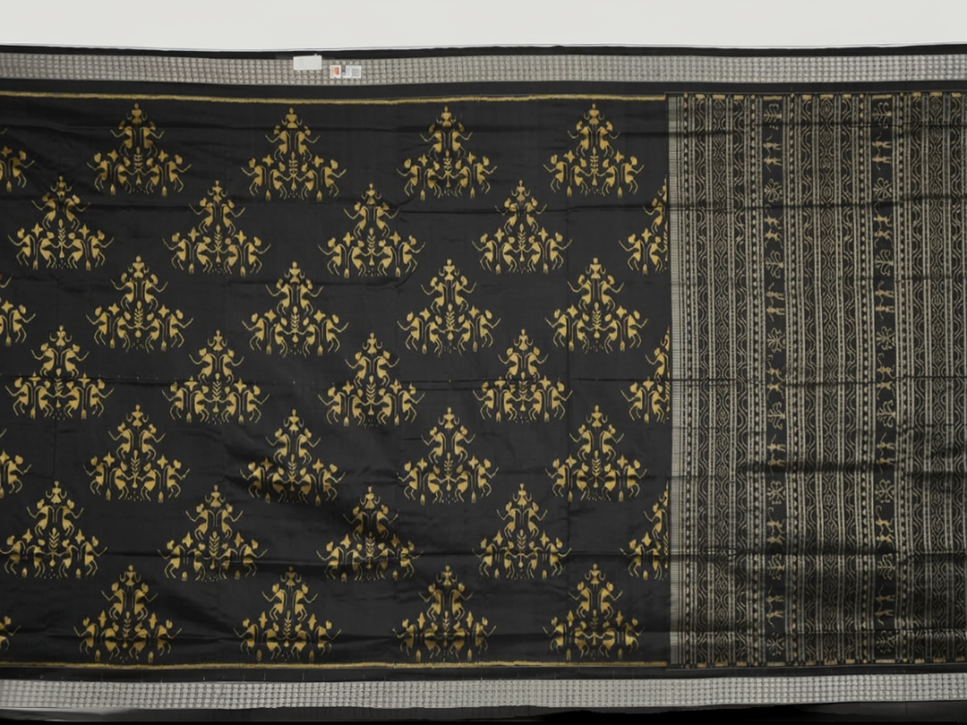 Close-up of the lustrous black Sambalpuri silk fabric, revealing its luxurious texture and fine weave.