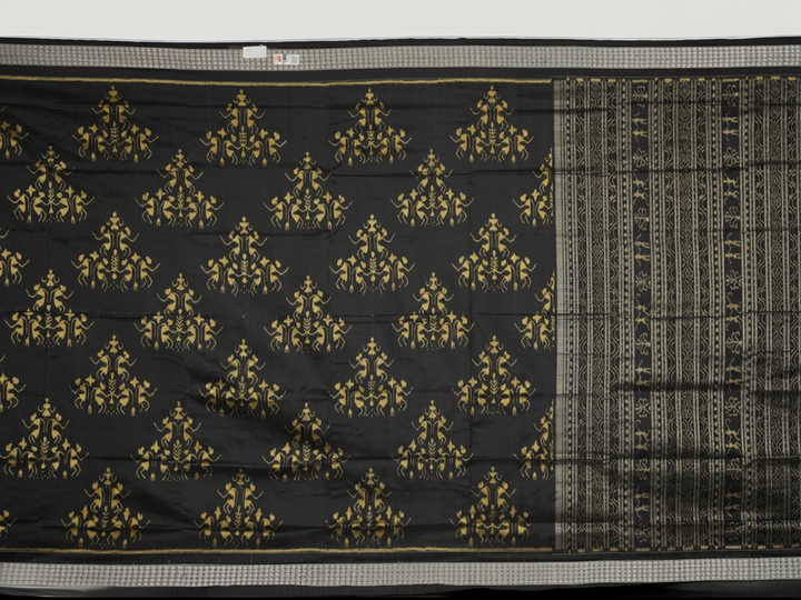 Close-up of the lustrous black Sambalpuri silk fabric, revealing its luxurious texture and fine weave.