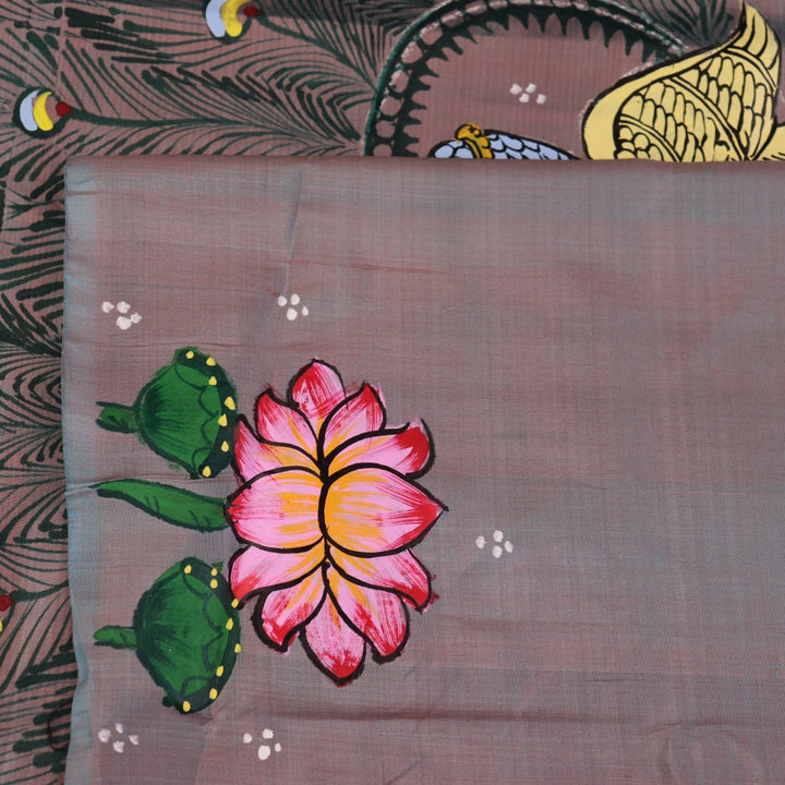 Close-up of hand-painted silk Patachitra saree fabric texture, showing the multicolor details and fine weave.