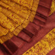Close-up showing the textured weave of a yellow and brown printed Tussar silk saree.