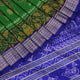 Close-up of green and blue Sambalpuri silk saree fabric showing intricate handloom weave and motif details.