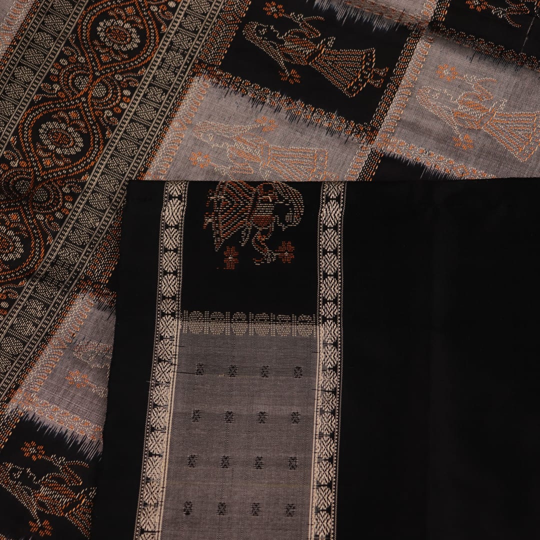 Close-up of intricate silk fabric texture in grey and black, featuring a traditional Bomkai butta pattern