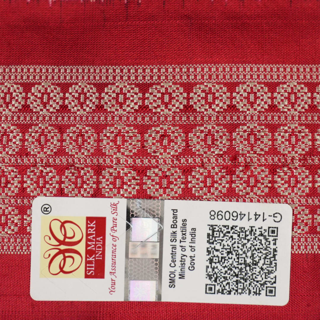 Close-up of the soft, lustrous grey Sambalpuri silk fabric texture, highlighting the intricate weave and motifs.