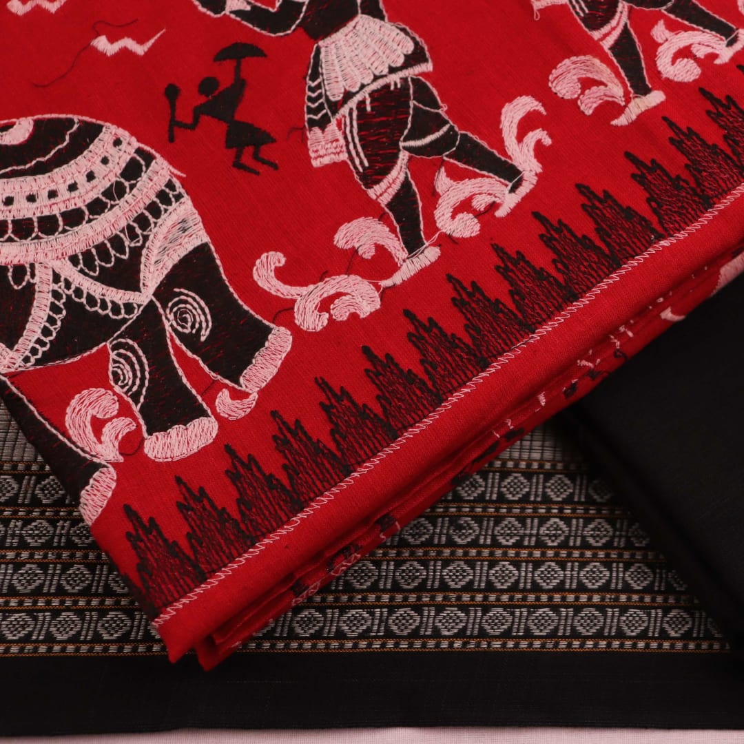 Close-up showcasing the intricate doll pattern on the cotton sambalpuri dress material in red and black.