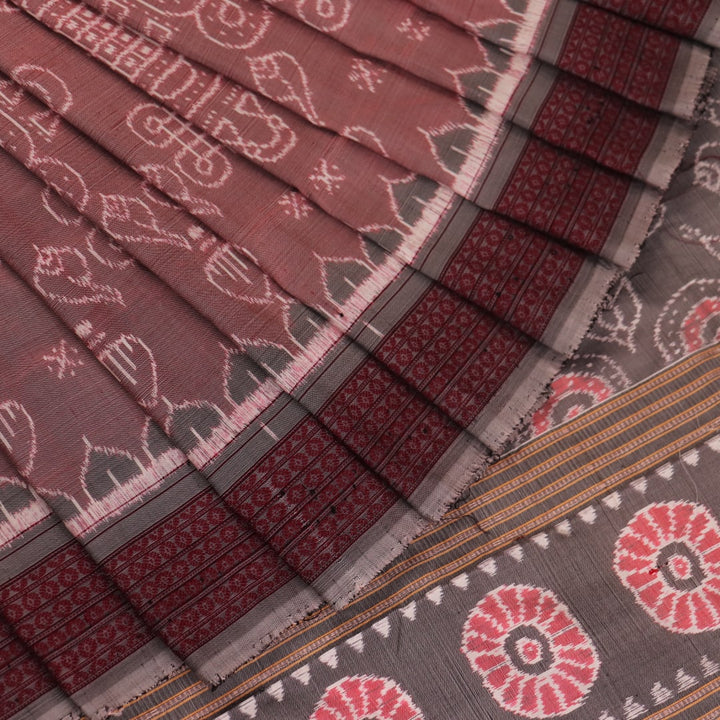 Close-up of a multicolored silk Sambalpuri saree fabric showing the intricate handloom texture and motifs.