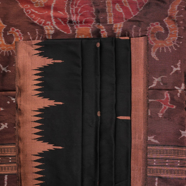 Extreme close-up showing the rich black and brown Sambalpuri Silk fabric texture and intricate handloom weave.