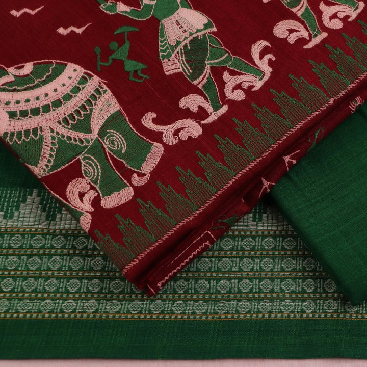 Close-up view of blouse piece in magenta cotton with green doll pattern