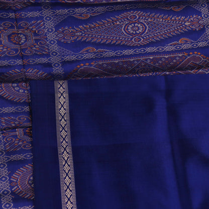 Textured close-up of yellow Bomkai silk saree fabric with blue butta pattern.