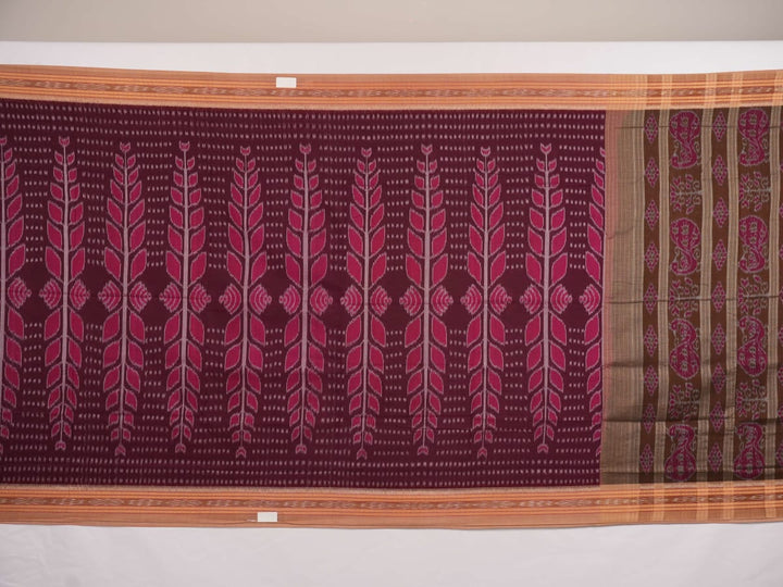 Model wearing an elegantly draped maroon and brown Sambalpuri cotton saree with traditional ikat motifs.