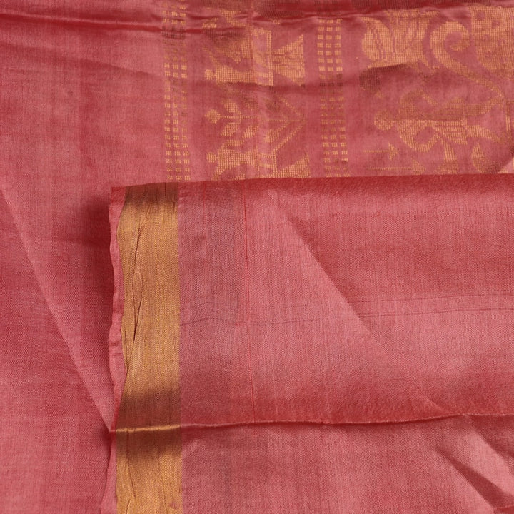 Close-up of intricate butta pattern woven on Tussar silk fabric in a maroon hue