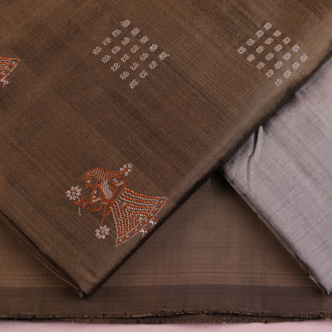 Detail of grey Bomkai silk blouse piece with butta pattern for dress material.