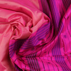 Close-up of plain peach and pink Sambalpuri silk saree fabric texture.