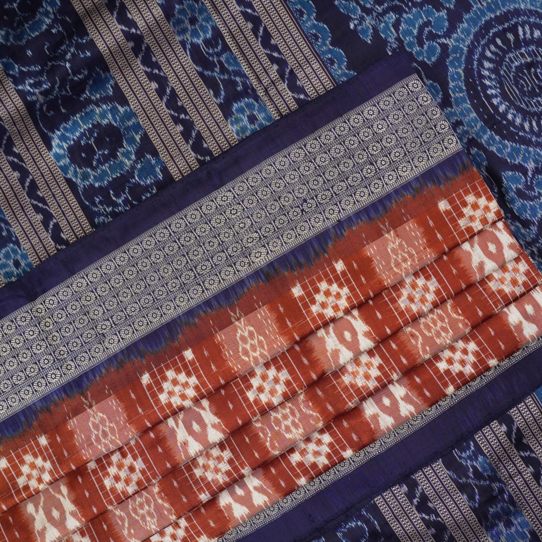 Close-up of the rich silk fabric texture of the Sambalpuri Saree, showing the intricate weave and slight sheen.