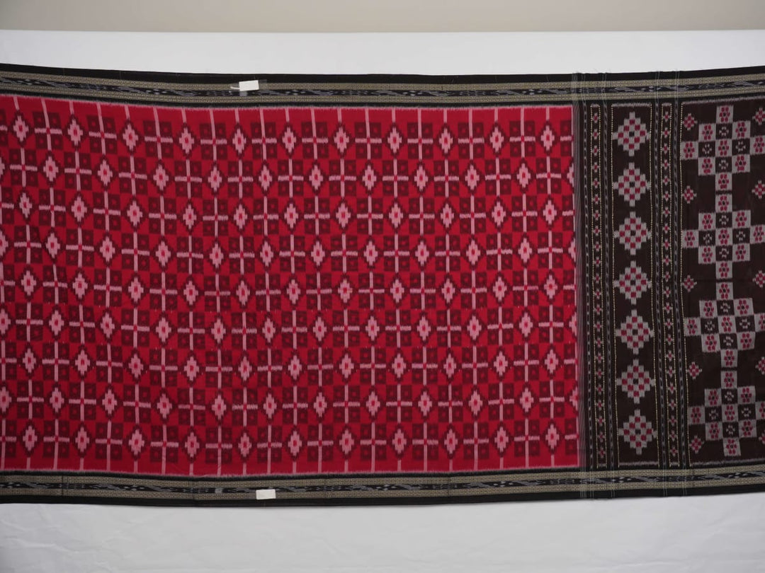 Model showcasing an elegant drape of a red and black Sambalpuri cotton handloom saree with traditional motifs