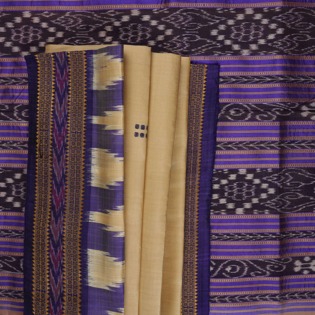 Model draped in a cream and blue Khandua silk saree with butta patterns, showcasing traditional styling.