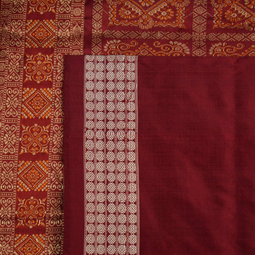 Ultra close-up of Bomkai silk saree fabric, revealing its luxurious texture and fine handloom weave.