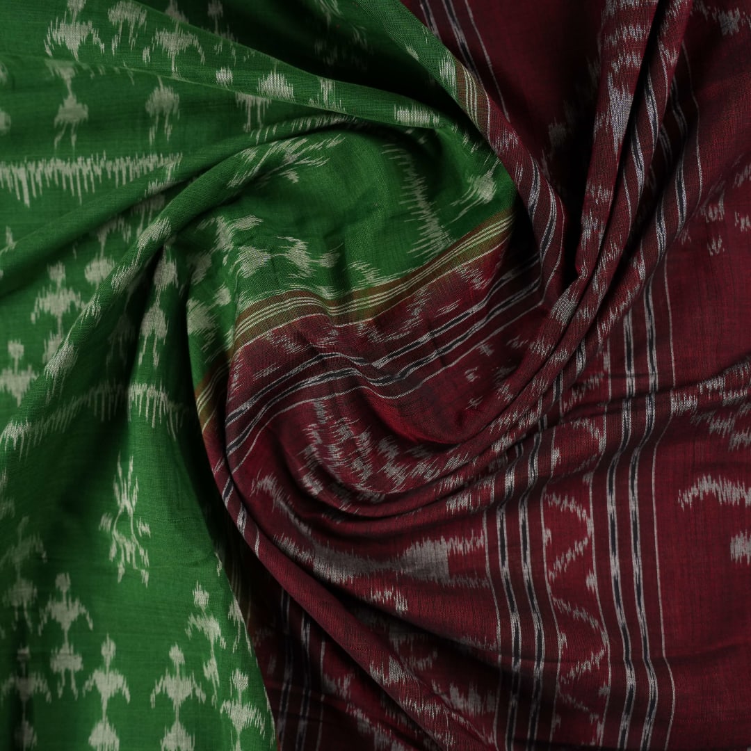 Model draped in a green and red Sambalpuri cotton saree with traditional motifs, styled for a classic look.