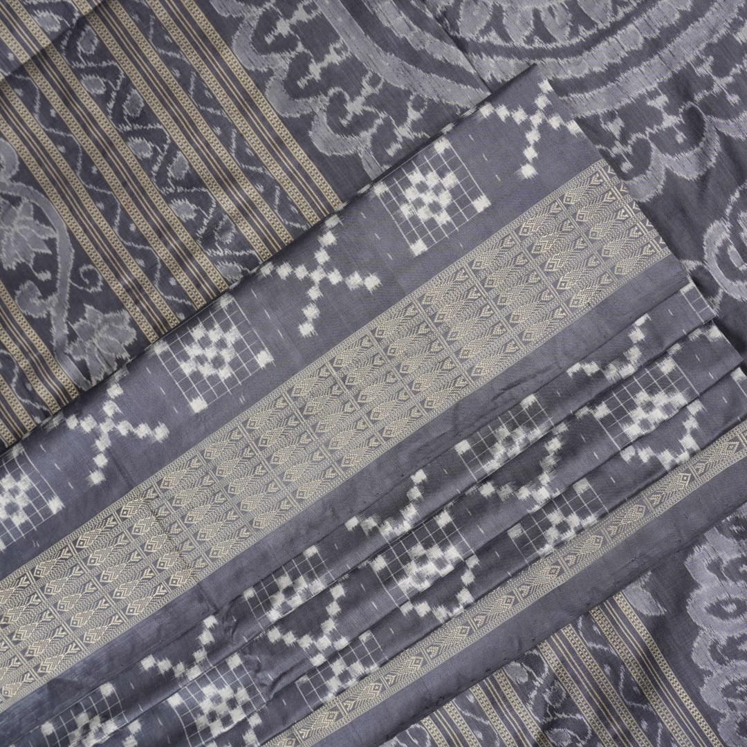 Close-up of the soft, luxurious grey Sambalpuri silk fabric texture with subtle weave details.
