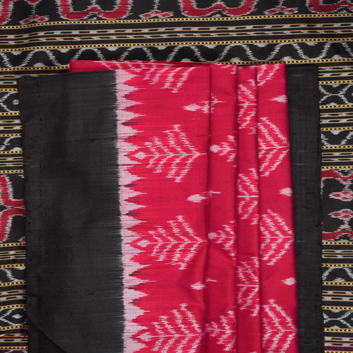 Close-up of the luxurious, handloom silk texture of the red Sambalpuri saree, showing the weave.