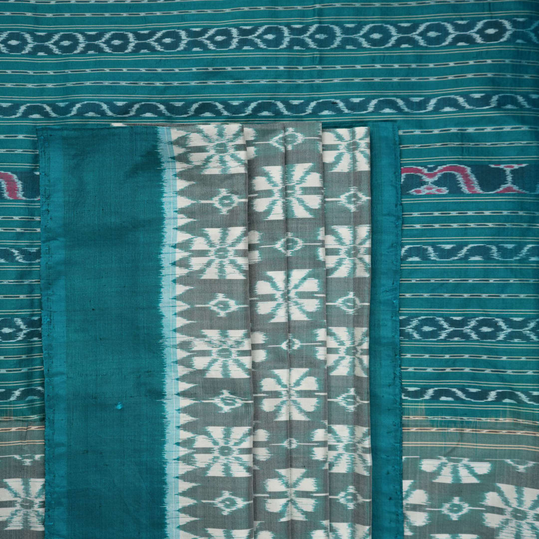 Close-up revealing the luxurious silk texture and subtle motif weave of the blue Sambalpuri saree.