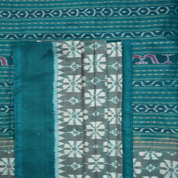 Close-up revealing the luxurious silk texture and subtle motif weave of the blue Sambalpuri saree.