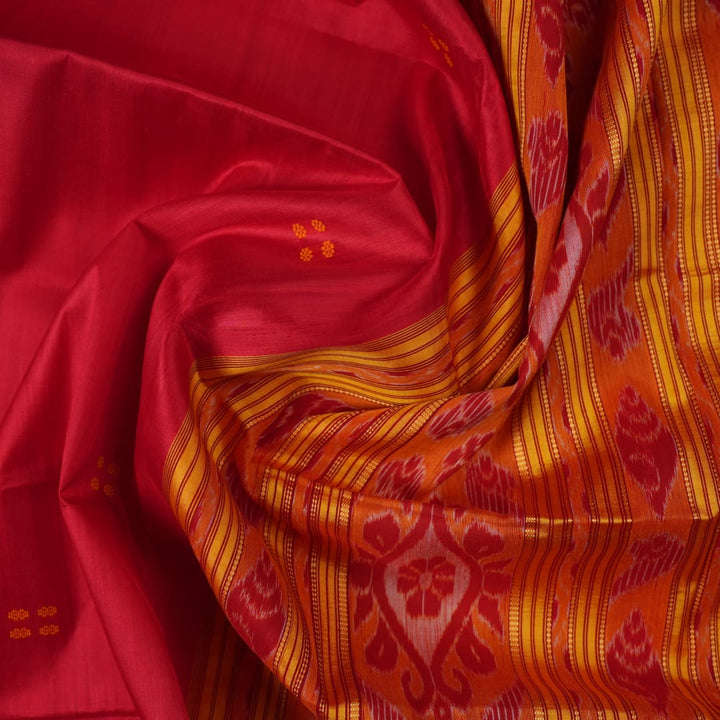 Model draped in a red and yellow Khandua silk saree with butta patterns for a traditional look.