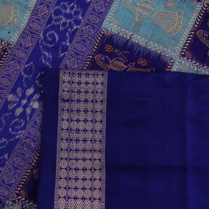 Close-up showcasing the silk texture of a blue and blue Bomkai silk saree with a butta pattern.