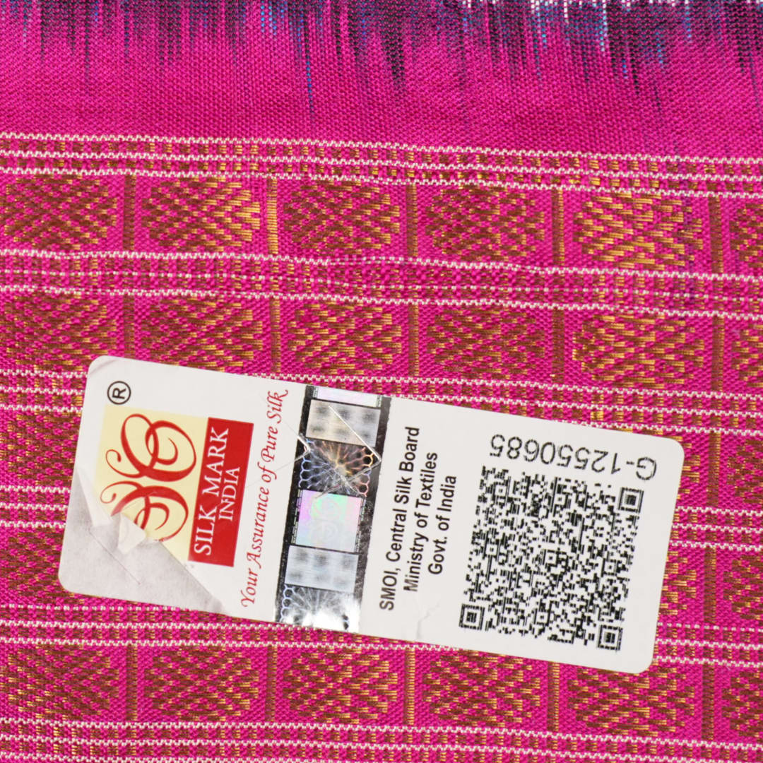 Close-up revealing the sheer tissue silk texture of the black saree, with subtle shimmering pink motifs.