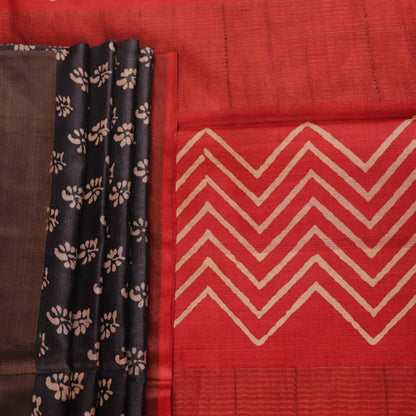 Close-up of the subtle slub and print on a handloom grey and rust Tussar silk saree fabric.