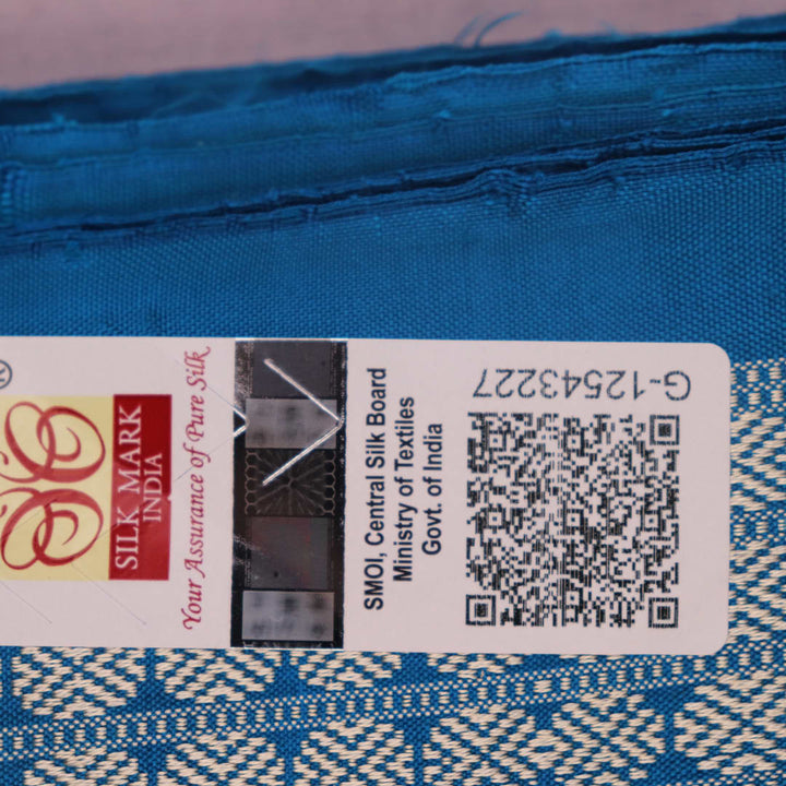 Close-up of Bomkai silk saree's textured weave, featuring magenta, blue, and butta pattern.