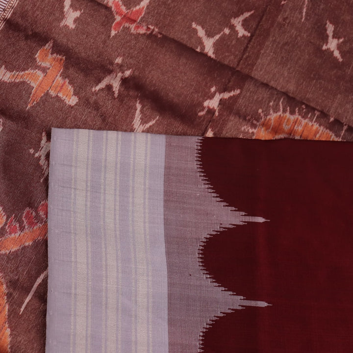 Close-up of grey and maroon Sambalpuri Silk Saree's butta pattern fabric texture.