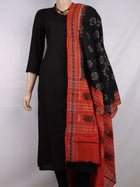 Black cotton Sambalpuri dupatta with rust motifs, styled on a mannequin