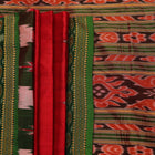 Red and green Khandua silk saree draped, showcasing the overall look and fall.