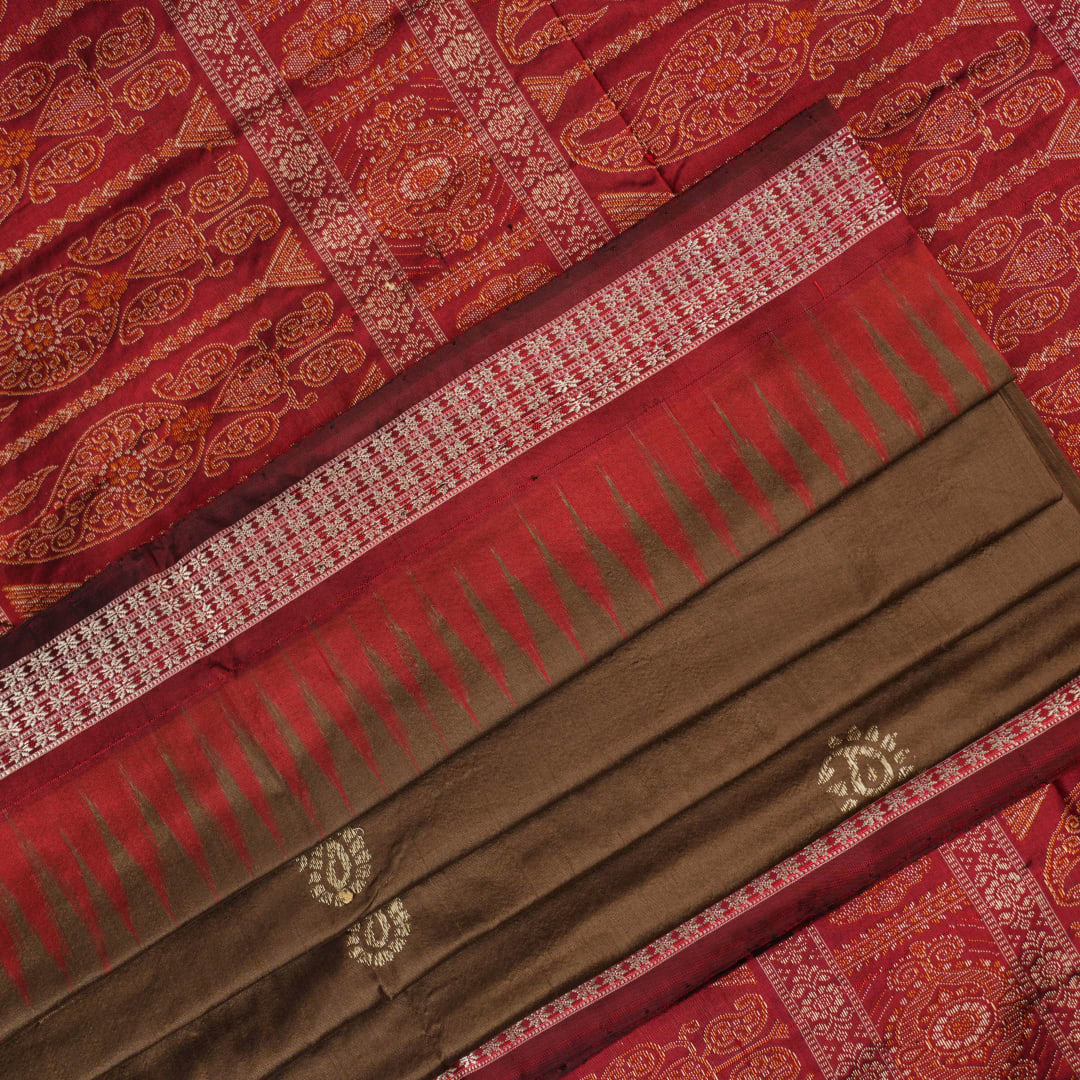 Close-up of Bomkai Silk Saree fabric, highlighting its luxurious brown silk texture and intricate weave.