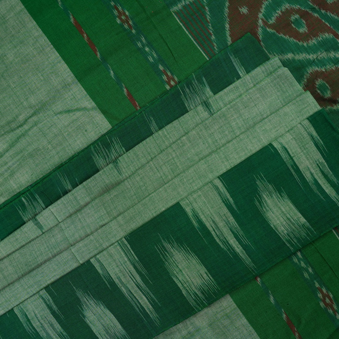 Model wearing a plain green Sambalpuri cotton saree styled elegantly to show the full handloom drape