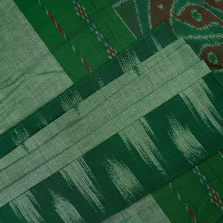 Model wearing a plain green Sambalpuri cotton saree styled elegantly to show the full handloom drape
