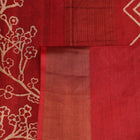 Close-up of the subtle slub and print on a handloom grey and rust Tussar silk saree fabric.