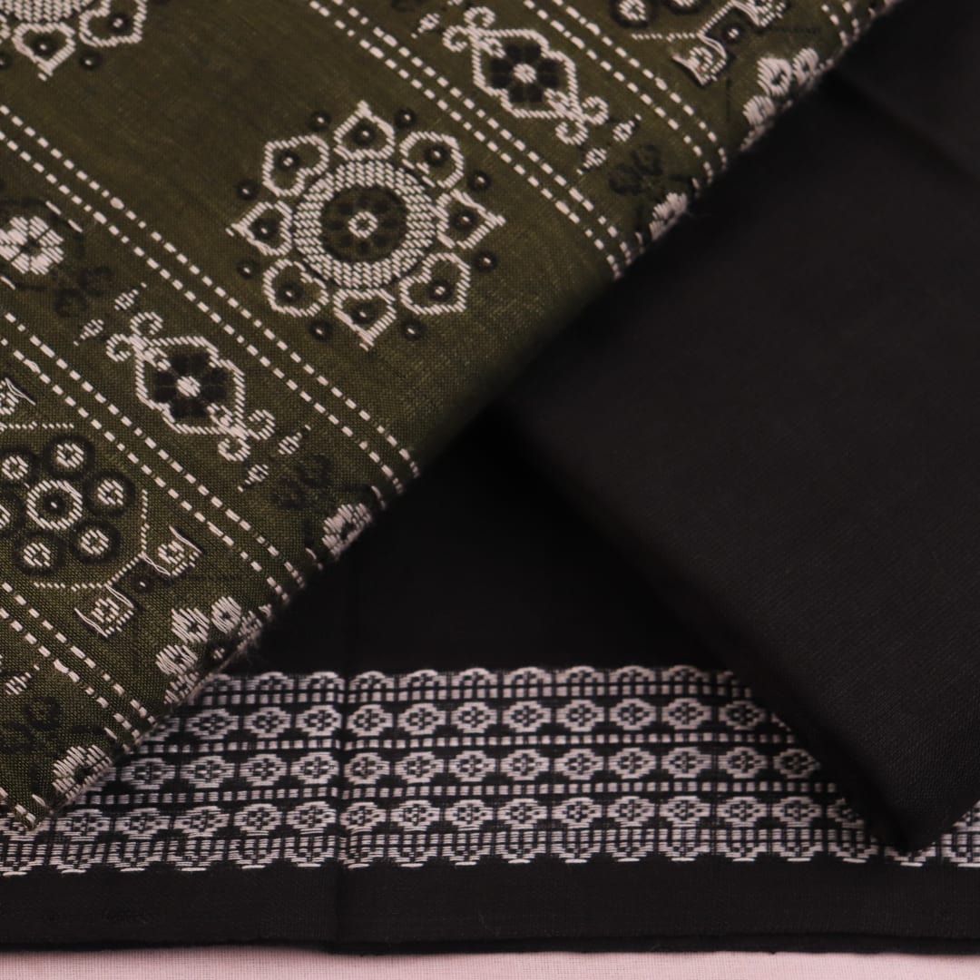 Detail of coordinating black Bomkai cotton blouse piece for green dress material.