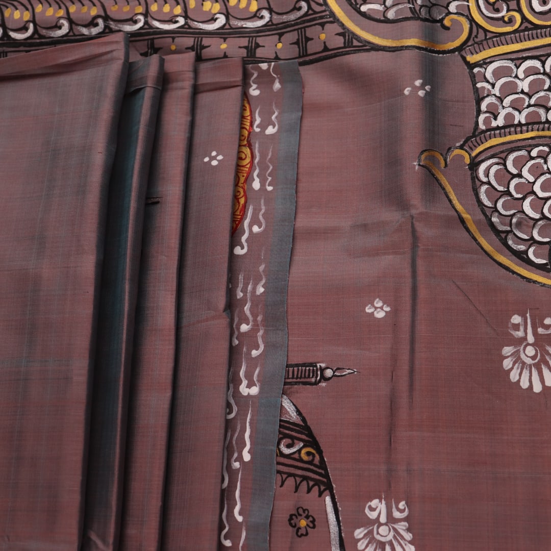 Close-up of multicolored Patachitra silk saree fabric texture showing hand-painted details.