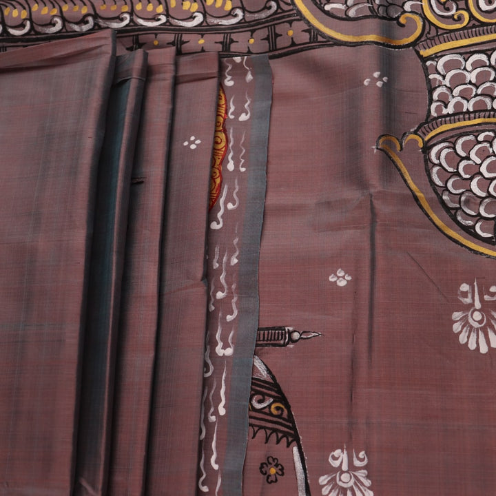 Close-up of multicolored Patachitra silk saree fabric texture showing hand-painted details.