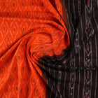 Model wearing an orange and black Sambalpuri cotton saree, styled in an elegant traditional drape.